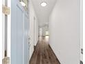 Inviting foyer showcasing sleek hardwood floors and crisp white walls, leading into the home at 4778 Se 25Th Loop, Ocala, FL 34480