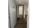 Condo entryway featuring modern dark wood floors and a view into the main living area at 571 Midway Trak # J202, Ocala, FL 34472