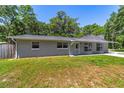 Charming single-story home featuring a well-maintained lawn and cozy front porch and lovely bay window at 6318 Nw 52Nd Ave, Ocala, FL 34482