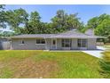 Charming single-story home featuring a well-maintained lawn and cozy front porch and lovely bay window at 6318 Nw 52Nd Ave, Ocala, FL 34482