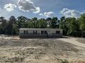 Charming single story home featuring horizontal siding, black shutters, and a front entrance with stairs at 6658 Sw 165Th Ct, Ocala, FL 34481