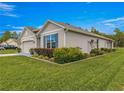 Well-maintained home featuring manicured shrubs and a vibrant green lawn at 716 Hickory Course Loop, Ocala, FL 34472