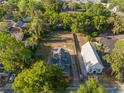 Aerial shot of a property with lush greenery, adjacent building, and ample parking space at 721 Ne 2Nd St, Ocala, FL 34470