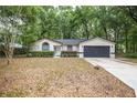 Charming single-story home features updated landscaping, attached garage, and inviting curb appeal at 7585 Sw 79Th Pl, Ocala, FL 34476