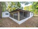 Backyard features a screened in porch and small shed, perfect for enjoying the outdoors at 7585 Sw 79Th Pl, Ocala, FL 34476