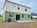 Two-story home's back exterior features large windows and a patio area, perfect for outdoor relaxation at 807 Glen Creek Ct, Fruitland Park, FL 34731