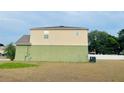 An eye-level view of the home's backyard showing the two-story construction and spacious lawn at 807 Glen Creek Ct, Fruitland Park, FL 34731