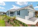 Charming single-story home featuring a two-car garage, lovely landscaping, and a covered entryway at 8798 Sw 79Th Pl, Ocala, FL 34481