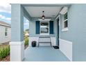 Inviting front porch with elegant columns, a stylish bench, and a charming overhead light fixture at 8798 Sw 79Th Pl, Ocala, FL 34481