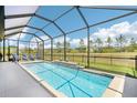 Relaxing screened-in pool area with serene views, perfect for enjoying the outdoors at 8875 Sw 58Th Street Rd, Ocala, FL 34481