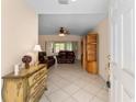 Inviting foyer featuring tile flooring, a decorative dresser and views into the living room at 9175 Se 118Th Loop, Summerfield, FL 34491
