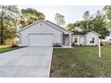 Charming one-story home with attached garage, manicured lawn, and inviting curb appeal at 9525 Sw 53Rd Cir, Ocala, FL 34476