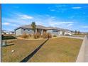 Spacious front lawn and landscaping complement this home's exterior, showcasing its curb appeal in the neighborhood at 10589 Sw 98Th Ln, Ocala, FL 34481