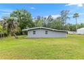 A spacious backyard featuring lush green grass and mature trees at 11065 Ne 42Nd St, Silver Springs, FL 34488