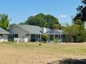 Lovely backyard featuring an enclosed pool and a screen patio perfect for outdoor dining and relaxation at 15069 Se 73Rd Ave, Summerfield, FL 34491