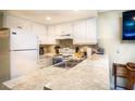 Efficient kitchen with white cabinets, counter seating, and modern appliances, ready for cooking at 20800 River Dr # A11, Dunnellon, FL 34431