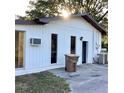 Back of home featuring exterior doors, windows and a large trash receptacle at 2138 Sw 9Th Rd, Ocala, FL 34471