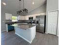 Modern kitchen with granite countertops, stainless steel appliances, and a stylish island at 4573 Sw Carnation Ct, Dunnellon, FL 34431