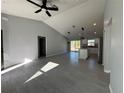 Spacious living room featuring vaulted ceilings, tile floors, and modern lighting fixtures at 4573 Sw Carnation Ct, Dunnellon, FL 34431