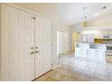 Bright foyer with tiled flooring that transitions to an open floor plan, leading to the kitchen at 5327 Sw 89Th St, Ocala, FL 34476