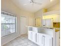 Bright kitchen with white cabinets, granite countertops, and a spacious breakfast bar island at 5327 Sw 89Th St, Ocala, FL 34476