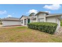 Well-maintained home with manicured green bushes and a screen door entrance at 5331 Old Hickory Ln, Fruitland Park, FL 34731