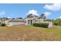 Charming home with a screen door, green bushes and a well-maintained lawn at 5331 Old Hickory Ln, Fruitland Park, FL 34731