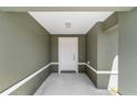 Inviting covered entry with concrete floor leading to the front door at 6756 Sw 151St Loop, Ocala, FL 34473