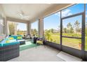 Enclosed patio with comfortable seating and view of the lush green backyard at 8090 Penrose Pl, Wildwood, FL 34785