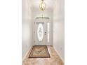 Bright foyer with a decorative door featuring sidelights and a tile floor with a decorative rug at 8955 Sw 86Th Loop, Ocala, FL 34481