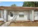 Inviting front porch area with a storm door and white-framed window at 10881 Sw 62Nd Avenue Rd, Ocala, FL 34476