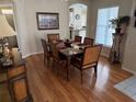 Formal dining room featuring hardwood floors and a stylish dining set at 11120 Sw 71St Terrace Rd, Ocala, FL 34481