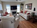Cozy living room with fireplace, comfortable seating, and bright natural light at 11120 Sw 71St Terrace Rd, Ocala, FL 34481