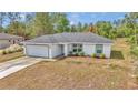 Lovely one-story home with a two-car garage, manicured landscaping, and freshly sealed driveway at 16848 Sw 41St Avenue Rd, Ocala, FL 34473