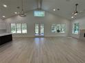 Bright, airy living room boasting high ceilings, beautiful floors, and large windows offering natural light at 18890 Sw 60Th St, Dunnellon, FL 34432