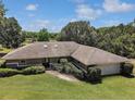 Well-maintained home featuring a stone pathway and meticulous landscaping enhancing its curb appeal at 26200 Se Highway 42, Umatilla, FL 32784