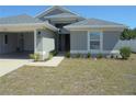 Charming single-story home with neutral-toned stucco, nicely landscaped front yard and 2 car garage at 4373 Ne 31St St, Ocala, FL 34470