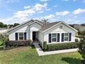 Inviting single-story home featuring a well-maintained lawn and classic blue shutters at 4721 Se 36Th St, Ocala, FL 34480