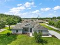 An aerial view of a well-maintained single-story home featuring a manicured lawn and established trees at 4743 Se 34Th St, Ocala, FL 34480