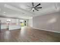 Bright, open-concept living space flows into kitchen with luxury vinyl plank flooring and coffered ceiling at 4743 Se 34Th St, Ocala, FL 34480