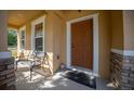 Charming front porch featuring a cozy bench and a welcoming entryway at 5128 Grassy Knoll Dr, Tavares, FL 32778