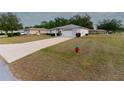 A quaint single-story home with a long driveway and lush green lawn in a quiet neighborhood at 6150 Sw 103Rd Loop, Ocala, FL 34476