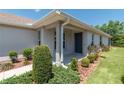 Inviting front entrance featuring a covered porch and tasteful landscaping at 7249 Sw 93Rd Ave, Ocala, FL 34481