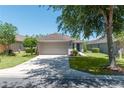 Charming single-story home with a well-maintained lawn and a two-car garage at 7249 Sw 93Rd Ave, Ocala, FL 34481