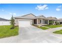 Inviting single-story home with a two-car garage, covered porch and landscaped front yard at 7827 Sw 56Th Pl, Ocala, FL 34474
