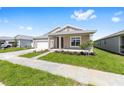 Attractive single-story home featuring a well-kept lawn and a covered front porch with columns at 7827 Sw 56Th Pl, Ocala, FL 34474