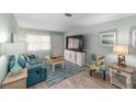 Comfortable living room with a teal sofa, entertainment center, and tropical-themed accents at 9333 Sw 97Th Pl # C, Ocala, FL 34481