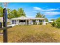 Inviting single-story home with a cozy front porch and green shutters at 10824 Sw 90Th Ter, Ocala, FL 34481
