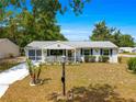 Charming single-story home featuring a cozy front porch and well-kept landscaping at 10824 Sw 90Th Ter, Ocala, FL 34481