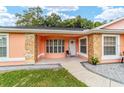 Inviting front porch with stone accents, tiled floor, and a charming entryway at 1109 Ne 22Nd Ave, Ocala, FL 34470